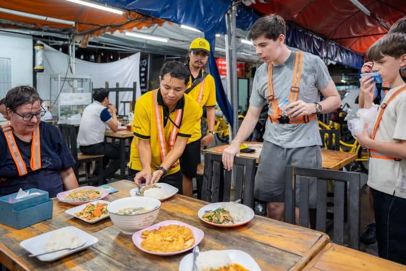 Bangkok by Night Cycling Tour with Street-food Meal - Chinatown after dark: lanterns, signs, and the night-market vibe
